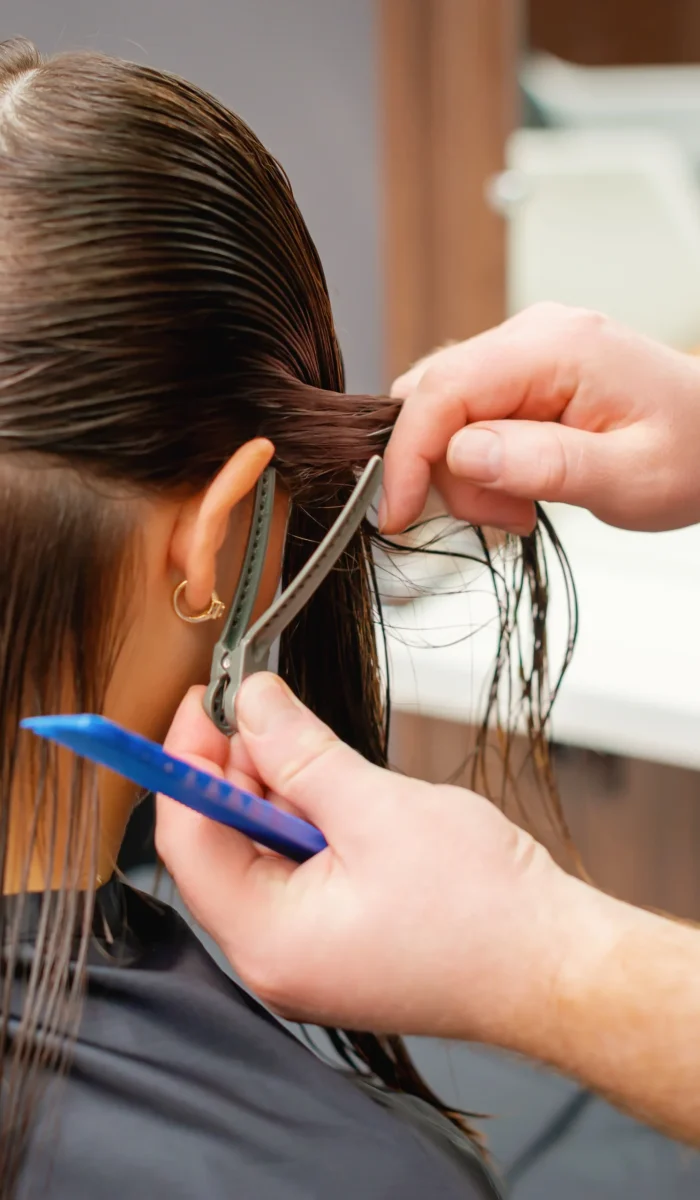 professional-hairdresser-cutting-hair-young-woman